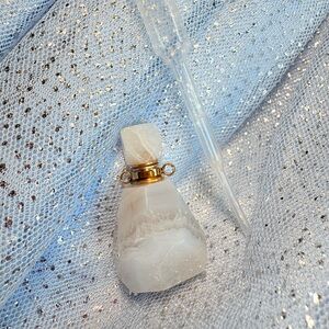Elegant White Crystal Bottle with Gold Accents